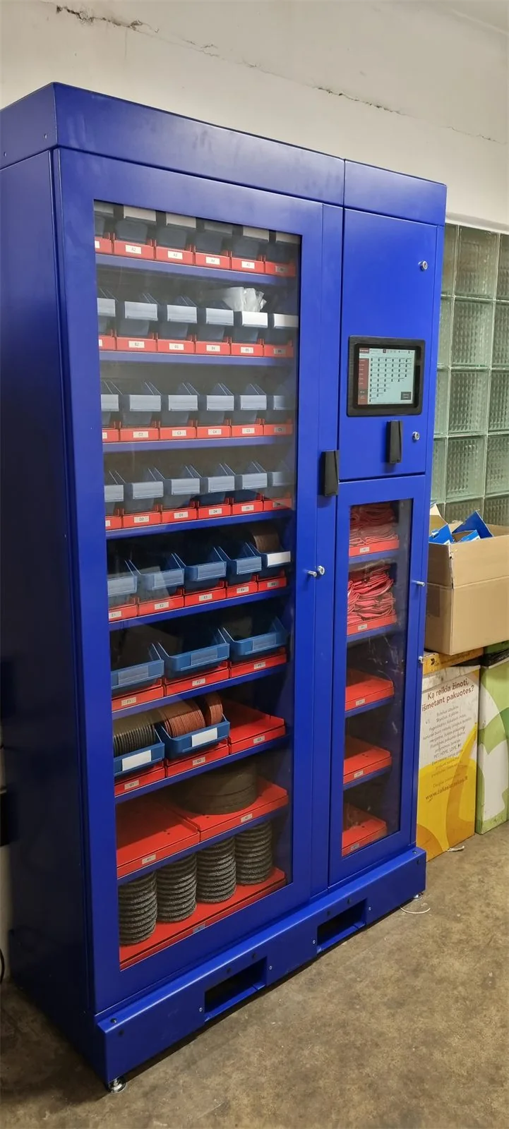 Inostorage cabinet in use, with bins on every shelf and the touch screen