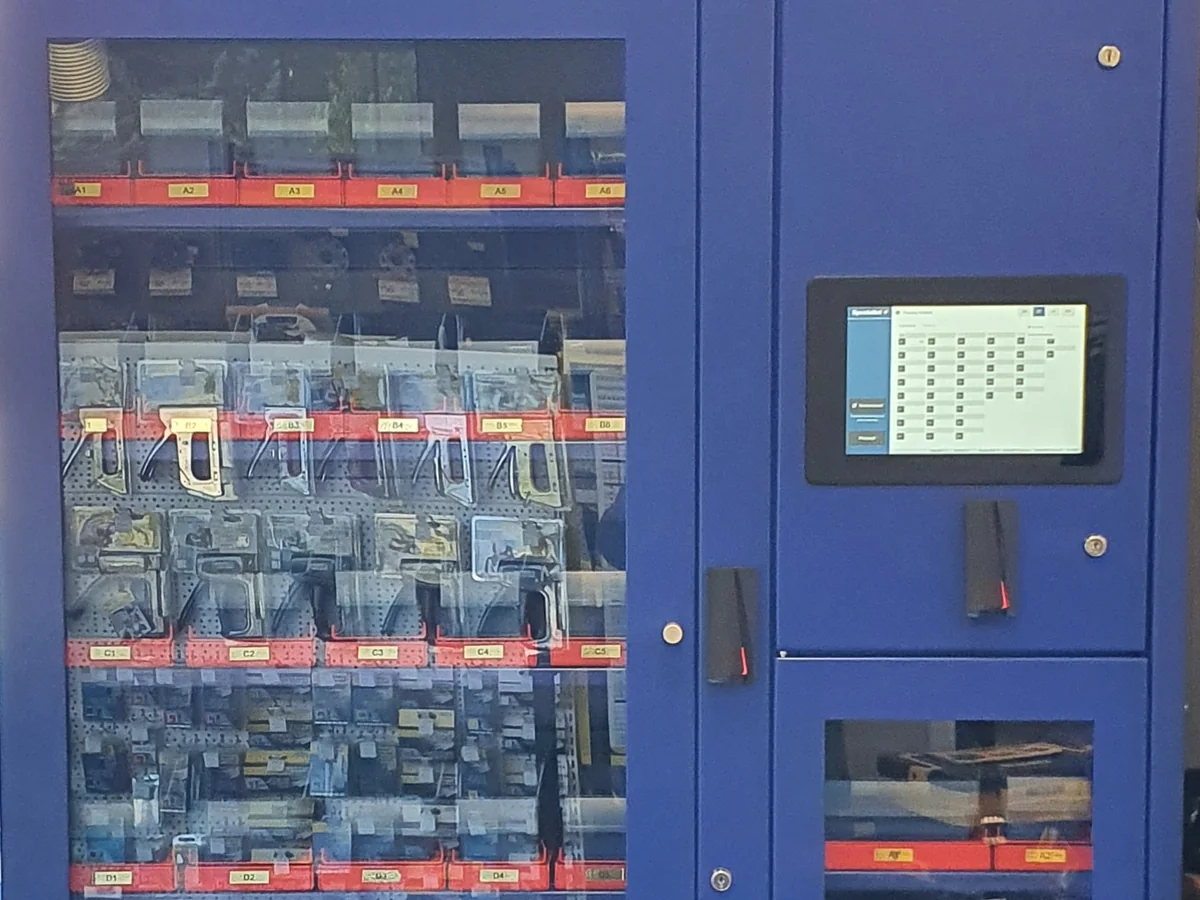 Hand tools in their packs on the shelves of an Inostorage cabinet, next to the touch screen and the card reader